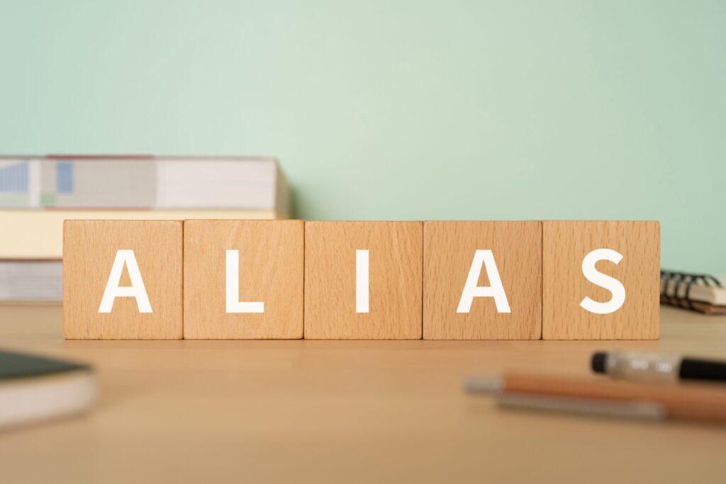 scrabble letters spelling out alias