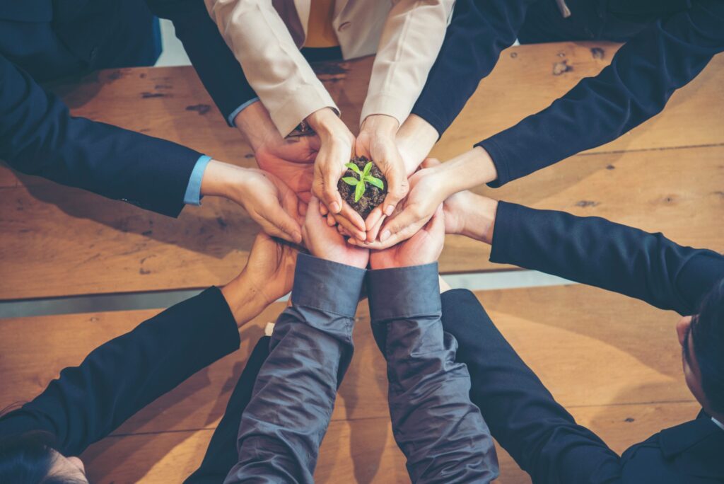 Green Business Meeting. United Partners Team with hands together