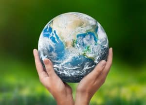 Hands raised to Earth globe. Environment protection. Global energy crisis, sustainability concept. Elements of this image furnished by NASA.